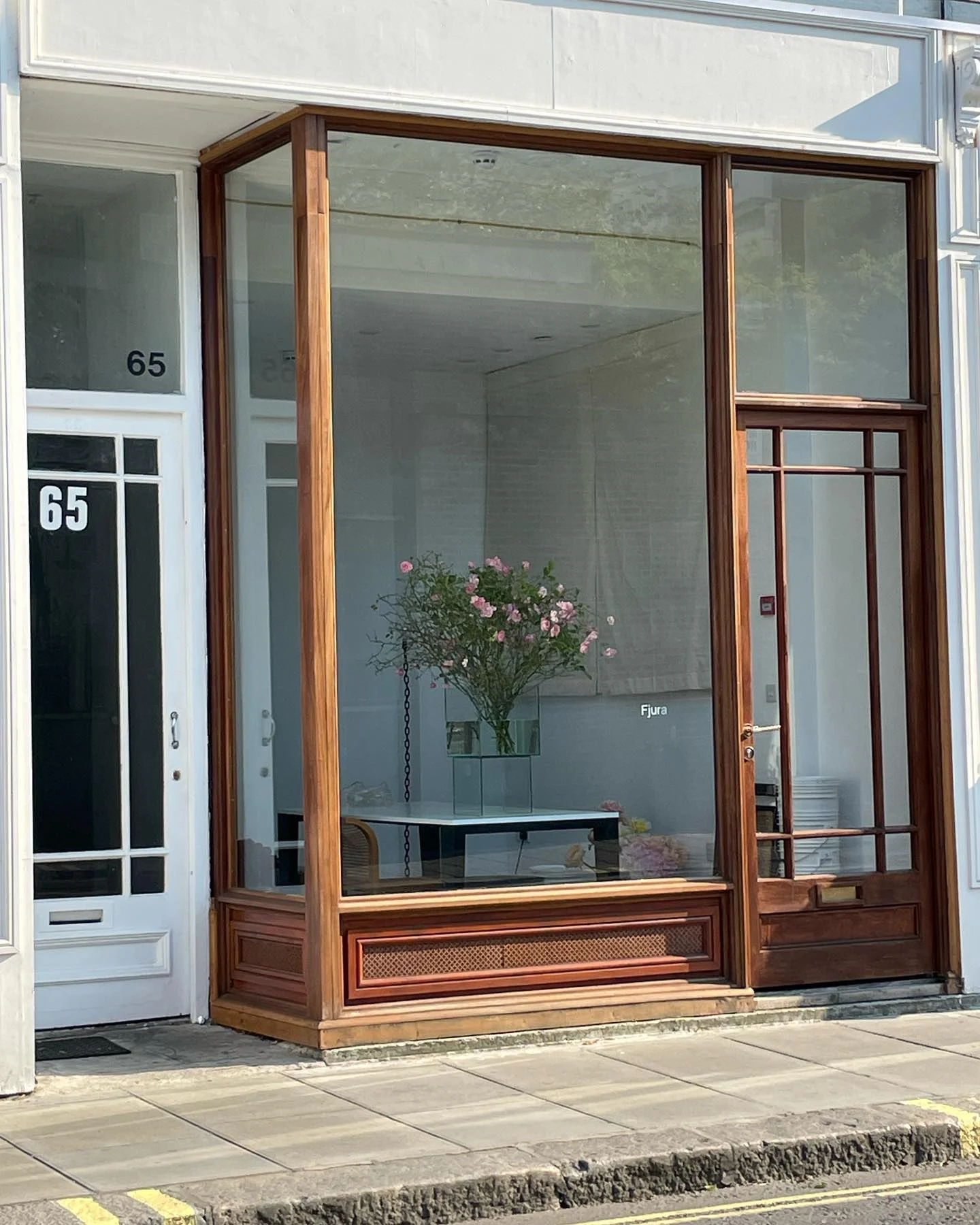Fjura storefront with flowers visible through the window