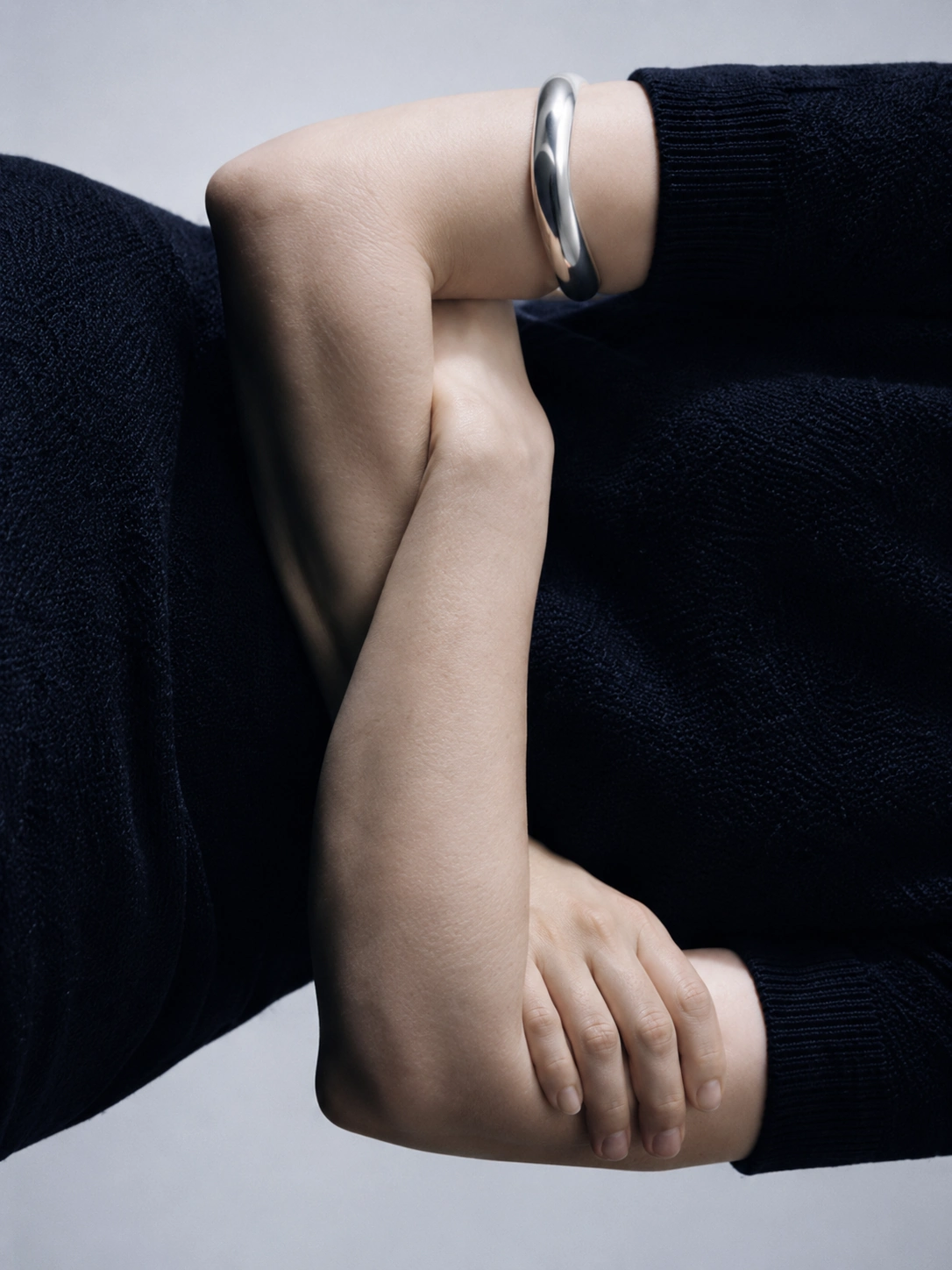 Subtle Senses study — folded arms with sculptural cuff