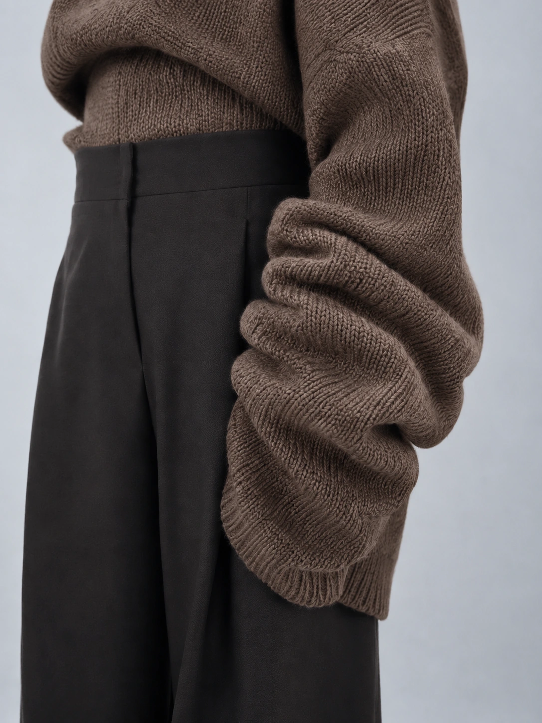 Subtle Senses study — brown knit and tailored trousers