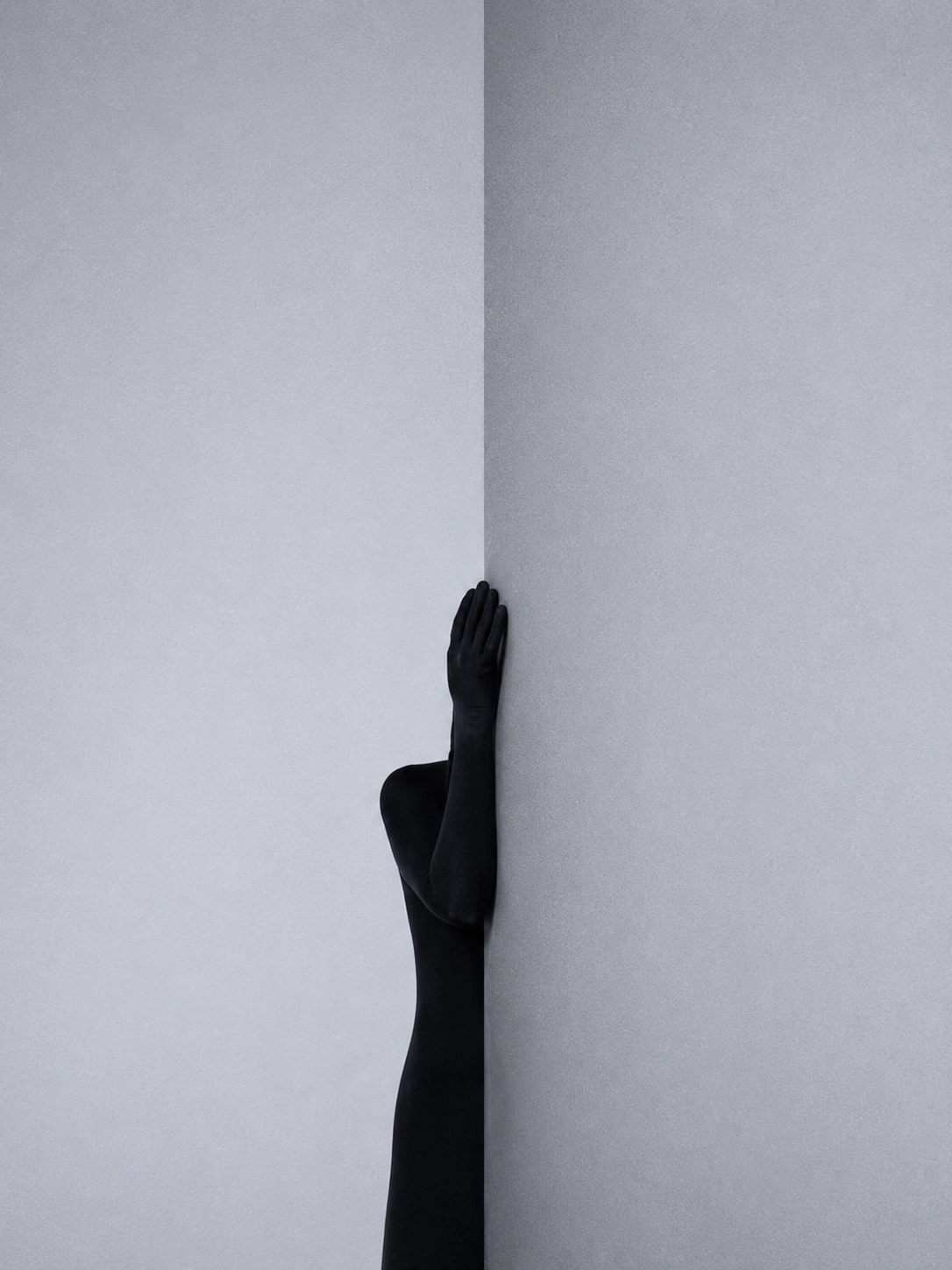 Subtle Senses study — black-clad figure partially hidden by a wall