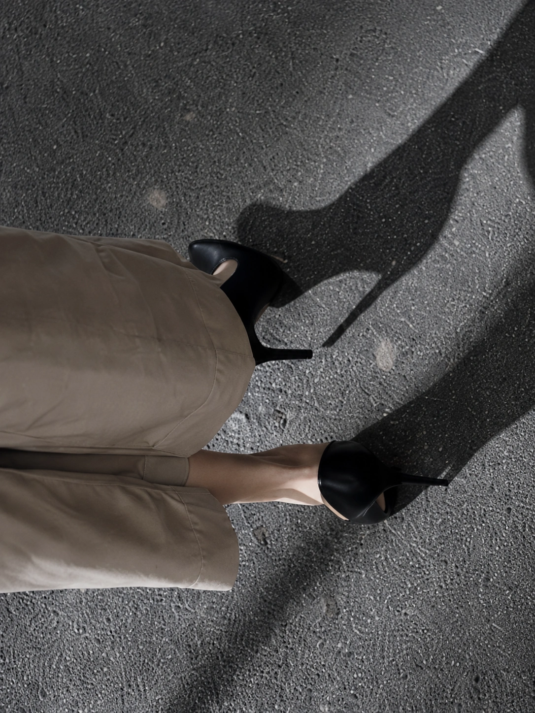 Subtle Senses study — black heels and long shadow